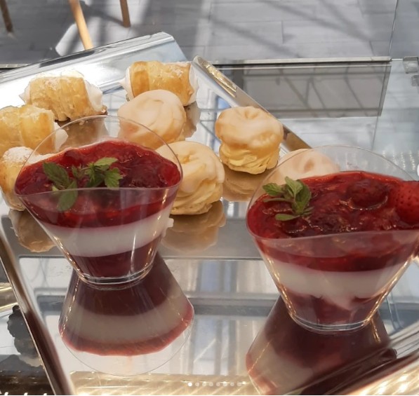 Panna cotta cups with berry coulis